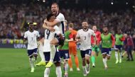 England's forward #09 Harry Kane (up) celebrates with England's forward #19 Ollie Watkins after winning the UEFA Euro 2024 semi-final football match between the Netherlands and England at the BVB Stadion in Dortmund on July 10, 2024. (Photo by Adrian Dennis / AFP)