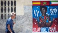 A man walks past a graffiti depicting Lamine Yamal in Rocafonda, the neighbourhood where Spain's forward grew up, in Mataro, 35km from Barcelona, on July 11, 2024. (Photo by Josep Lago / AFP)