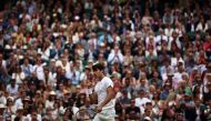 Spain's Carlos Alcaraz reacts after scoring a point against Russia's Daniil Medvedev during their men's singles semi-final tennis match on the twelfth day of the 2024 Wimbledon Championships at The All England Lawn Tennis and Croquet Club in Wimbledon, southwest London, on July 12, 2024. (Photo by HENRY NICHOLLS / AFP)