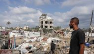 A Palestinian man looks at damaged tents at the site of Israeli bombardment a day earlier on the al-Mawasi displacement camp on July 14, 2024. (Photo by Bashar Taleb / AFP)