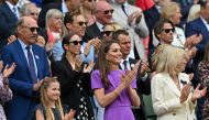 Britain's Catherine, Princess of Wales (C) and her daughter Britain's Princess Charlotte of Wales (L) applaud the players from the Royal Box on Centre Court prior to the start of the men's singles final tennis match on the fourteenth day of the 2024 Wimbledon Championships at The All England Lawn Tennis and Croquet Club in Wimbledon, southwest London, on July 14, 2024. (Photo by ANDREJ ISAKOVIC / AFP) 