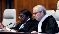 Judge and President of the International Court of Justice (ICJ), Nawaf Salam (R) delivers a non-binding ruling on the legal consequences of the Israeli occupation of the West Bank and East Jerusalem at the International Court of Justice (ICJ) in The Hague on July 19, 2024. (Photo by Nick Gammon / AFP)
