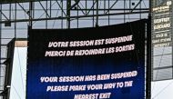 A giant screen informs about the match's interruption following incidents in the men's group B football match between Argentina and Morocco on July 24, 2024. (Photo by Arnaud Finistre / AFP)
 