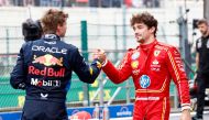 Red Bull Racing's Dutch driver Max Verstappen (L) shakes hands with Ferrari's Monegasque driver Charles Leclerc after the qualifying session ahead of the Formula One Belgian Grand Prix at the Spa-Francorchamps Circuit in Spa on July 27, 2024. (Photo by SIMON WOHLFAHRT / AFP)
