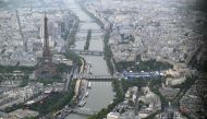 A photograph taken from an helicopter on July 26, 2024 shows an aerial view of the Eiffel Tower along the Seine river during the opening ceremony of the Paris 2024 Olympic Games in Paris. (Photo by Lionel BONAVENTURE / POOL / AFP)