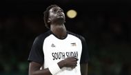 South Sudan's #10 Jt Thor stands at attention during the national anthems prior to the men's preliminary round group C basketball match between South Sudan and Puerto Rico during the Paris 2024 Olympic Games at the Pierre-Mauroy stadium in Villeneuve-d'Ascq, northern France, on July 28, 2024. (Photo by Sameer Al-Doumy / AFP)