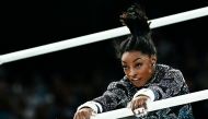 US' Simone Biles competes in the uneven bars event of the artistic gymnastics women's qualification during the Paris 2024 Olympic Games at the Bercy Arena in Paris, on July 28, 2024. (Photo by Loic VENANCE / AFP)