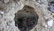 A Palestinian man inspects the damage following an Israeli strike on the Khadija school housing displaced people in Deir al-Balah, in the central Gaza Strip on July 27, 2024.(Photo by Eyad Baba / AFP)