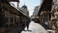 Palestinians walk through a deserted commercial area in Nablus in the Israeli-occupied West Bank during a general strike on July 31, 2024. (Photo by Zain Jaafar / AFP)