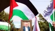 People hold up the Palestinian flag and a portrait of assassinated Hamas chief Ismail Haniyeh during a rally at Tehran University, in the Iranian capital Tehran on July 31, 2024. (Photo by AFP)