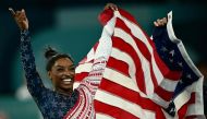 US' Simone Biles celebrates after team USA won the artistic gymnastics women's team final during the Paris 2024 Olympic Games at the Bercy Arena in Paris, on July 30, 2024. (Photo by Loic Venance / AFP)