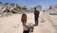 Displaced Palestinians return to Bani Suhayla and neighbouring towns east of Khan Yunis following reports of Israeli forces withdrawing from the area in the southern Gaza Strip on July 30, 2024. (Photo by Bashar Taleb / AFP)