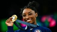 US' Simone Biles poses with her gold medal during the podium ceremony after the artistic gymnastics women's all around final during the Paris 2024 Olympic Games at the Bercy Arena in Paris, on August 1, 2024. (Photo by Loic Venance / AFP)