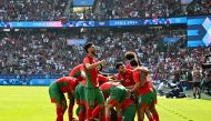 Morocco's players celebrate after scoring their third goal during the men's quarter-final football match between Morocco and the USA at the Paris 2024 Olympic Games at the Parc des Princes in Paris on August 2, 2024. Photo by Paul ELLIS / AFP.