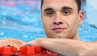 Hungary's Kristof Milak celebrates after winning the final of the men's 100m butterfly swimming event during the Paris 2024 Olympic Games at the Paris La Defense Arena in Nanterre, west of Paris, on August 3, 2024. (Photo by Jonathan NACKSTRAND / AFP)
