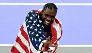 US' Noah Lyles celebrates after winning the men's 100m final of the athletics event at the Paris 2024 Olympic Games at Stade de France in Saint-Denis, north of Paris, on August 4, 2024. (Photo by Loic VENANCE / AFP)
