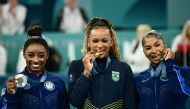 US' Simone Biles (silver), Brazil's Rebeca Andrade (gold) and US' Jordan Chiles (bronze) pose during the podium ceremony for the artistic gymnastics women's floor exercise event of the Paris 2024 Olympic Games at the Bercy Arena in Paris, on August 5, 2024. (Photo by Loic VENANCE / AFP)