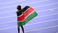 Kenya's Beatrice Chebet celebrates after winning the women's 5000m final of the athletics event at the Paris 2024 Olympic Games at Stade de France in Saint-Denis, north of Paris, on August 5, 2024. (Photo by MARTIN BERNETTI / AFP)
