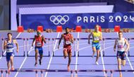 Qatar's Abderrahman Samba (centre) in action during the men's 400m hurdles heats, yesterday.