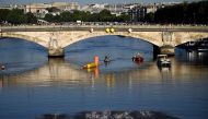 TOPSHOT - Athletes compete in the swimming race in the seine, during the mixed's relay triathlon, at the Paris 2024 Olympic Games, in central Paris, on August 5, 2024. (Photo by JULIEN DE ROSA / AFP)