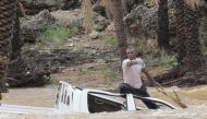 File photo: A man gestures as he tries to save a vehicle swept away by flood waters in Yemen's island of Socotra November 2, 2015.Reuters
