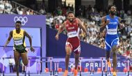 Jamaica's Malik James-King, Qatar's Abderrahman Samba and British Virgin Islands' Kyron McMaster compete in the men's 400m hurdles semi-final of the athletics event at the Paris 2024 Olympic Games at Stade de France in Saint-Denis, north of Paris, on August 7, 2024. (Photo by Jewel Samad / AFP)
