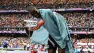 Botswana's Letsile Tebogo celebrates after winning the men's 200m final of the athletics event at the Paris 2024 Olympic Games at Stade de France in Saint-Denis, north of Paris, on August 8, 2024. (Photo by Jewel Samad / AFP)