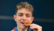 British gold medalist Toby Roberts poses on the podium after the men's sport climbing lead final during the Paris 2024 Olympic Games at Le Bourget Sport Climbing Venue in Le Bourget on August 9, 2024. (Photo by Fabrice COFFRINI / AFP)
