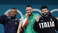 Gold medallist Bulgaria's Karlos May Nasar (C), silver medallist Colombia's Yeison Lopez (L) and bronze medallist Italy's Antonino Pizzolato (R) pose on the podium after the men's -89kg weightlifting event during the Paris 2024 Olympic Games at the South Paris Arena in Paris, on August 9, 2024. Photo by Dimitar DILKOFF / AFP.