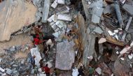 People inspect the damage in Gaza City's Sheikh Radwan neighbourhood in Gaza City following Israeli bombardment on August 11, 2024. (Photo by Omar Al-Qattaa / AFP)

