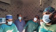 Dr. Mansour Ali (third left) performing a surgery during a medical mission.