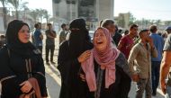 A Palestinian woman mourns a family member killed in Israeli bombardment, at the Nasser hospital in Khan Yunis in the southern Gaza Strip on August 14, 2024. (Photo by Bashar Taleb / AFP)