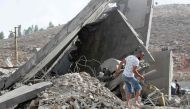 A man inspects the damage to a building after an Israeli strike in the southern town of Kfour, in the Nabatiyeh district, on August 17, 2024. Photo by Mahmoud ZAYYAT / AFP