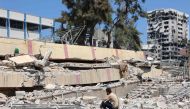 A man looks at the debris after an Israeli strike on a school, housing displaced Palestinians, in the Rimal neighbourhood of central Gaza City on August 20, 2024. (Photo by Omar AL-QATTAA / AFP)
