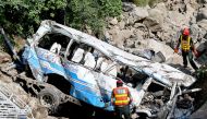 Rescue personnel inspect the site of a bus accident that killed 23 people after it plunged into a ravine at Soon village near Kahuta, Punjab province on August 25, 2024. Photo by Aamir QURESHI / AFP.