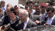 Lebanese Prime Minister Salim Hoss (centre) is showered with rice during a visit to  the southern Lebanese village of Khiam on May 25, 2000, after the withdrawal of Israeli forces from the western sector of the occupied zone in southern Lebanon. (AFP)