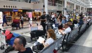 Passengers wait for their flights at the Beirut International Airport in Beirut yesterday. (AFP)