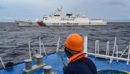 A China Coast Guard ship is seen from the Philippine Coast Guard vessel BRP Cabra during a supply mission to Sabina Shoal in disputed waters of the South China Sea on August 26, 2024. (Photo by Jam Sta Rosa / AFP)