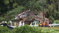 This photo shows rescue workers outside a house that was hit by a landslide in Gamagori, Aichi prefecture on August 28, 2024. Photo by JIJI Press / AFP