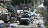 Israeli military armoured vehicles including a bulldozer block a road during a raid in the al-Faraa camp for Palestinian refugees near Tubas city in the occupied West Bank on August 28, 2024. Photo by RONALDO SCHEMIDT / AFP.