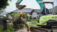 Workers remove a fallen tree brought down by strong winds from Typhoon Shanshan in Usa, Oita prefecture on August 29, 2024. Photo by Yuichi YAMAZAKI / AFP