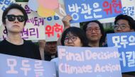 Climate activists hold banners outside South Korea's Constitutional Court in Seoul on August 29, 2024. Photo by ANTHONY WALLACE / AFP