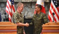 Philippines' Military Chief General Romeo Brawner (R) shakes hands with US Indo-Pacific Commander Admiral Samuel Paparo during a joint press conference after the Philippines-US Mutual Defence Board meeting at the Philippine Military Academy in Baguio on August 29, 2024. Photo by Ted ALJIBE / AFP