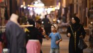 People walk along an alley during the reopening of restored historic bazaars that were damaged during the Syrian conflict in the northern city of Aleppo on August 28, 2024. (Photo by AFP)