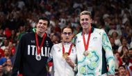 (From left) Silver medalist Italy's Simone Barlaam, gold medalist France's Ugo Didier and bronze medalist Australian Brenden Hall celebrate on the podium of the men's S9 400m freestyle swimming event during the Paris 2024 Paralympic Games at The Paris La Defense Arena in Nanterre, west of Paris on August 29, 2024. (Photo by Franck Fife / AFP)