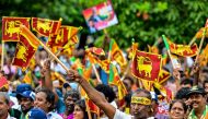 Supporters of Sri Lanka's president and United National Party presidential candidate Ranil Wickremesinghe, wave the country's national flag during an election rally ahead of the upcoming presidential elections in Colombo on August 28, 2024. Photo by Ishara S. KODIKARA / AFP.