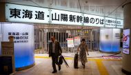 People walk in front of closed ticket gates for the Tokaido Shinkansen as train operations between Tokyo and Nagoya are suspended, in Tokyo Station, due to Typhoon Shanshan crawling across Japan on August 31, 2024. (Photo by Philip FONG / AFP)
