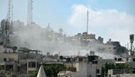 Smoke rises above buildings during an Israeli occupation army raid in Jenin in the occupied-West Bank on August 31, 2024. Photo by RONALDO SCHEMIDT / AFP.
