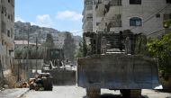 Israeli bulldozers drive in a street during an army raid in Jenin in the occupied-West Bank on August 31, 2024. (Photo by RONALDO SCHEMIDT / AFP)
