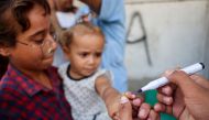 A health worker marks the finger of a Palestinian child that was vaccinated against Polio in Zawayda in the central Gaza Strip on September 1, 2024. Photo by Eyad BABA / AFP